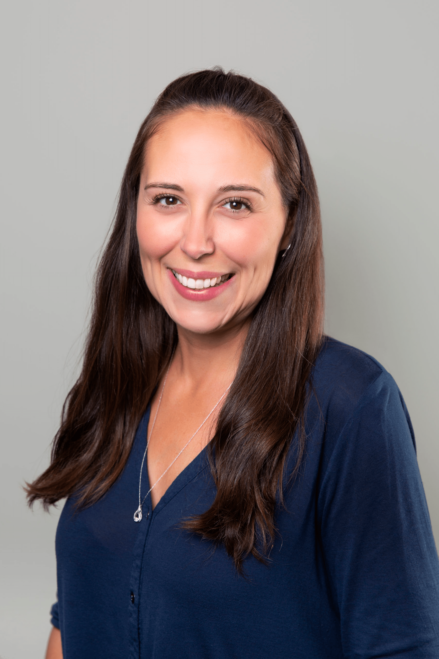 A woman named Erin, with long brown hair, wearing a blue shirt, representing Dr. Gary Wessels Inc.